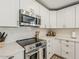 This gorgeous kitchen is equipped with white cabinets, stainless steel appliances, and sleek countertops at 8423 E Heatherbrae Dr, Scottsdale, AZ 85251