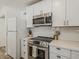 Well-equipped kitchen featuring stainless steel appliances, white countertops, and white subway tile backsplash at 8423 E Heatherbrae Dr, Scottsdale, AZ 85251