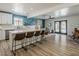 Inviting open concept living room with hardwood floors, a kitchen bar, and backyard access at 8423 E Heatherbrae Dr, Scottsdale, AZ 85251