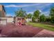 Backyard featuring grassy area, concrete pavers, outdoor shed and a basketball hoop at 8905 W Jefferson St, Tolleson, AZ 85353