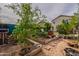 This backyard contains wooden planter boxes and a small pomegranate tree at 8905 W Jefferson St, Tolleson, AZ 85353