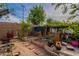 A view of a backyard featuring wooden planter boxes, red brick pavers, and a brick wall at 8905 W Jefferson St, Tolleson, AZ 85353