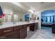 Bright bathroom with dual sinks, modern finishes, and a view into the main bedroom at 8905 W Jefferson St, Tolleson, AZ 85353