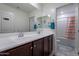 Well-lit bathroom featuring dual sinks, white countertops, and a separate shower and toilet area at 8905 W Jefferson St, Tolleson, AZ 85353