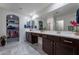 Bright bathroom with dual sinks, modern finishes, and a walk-in closet at 8905 W Jefferson St, Tolleson, AZ 85353