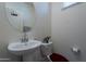 Stylish half bathroom with modern fixtures, oval mirror, and bright, neutral decor at 8905 W Jefferson St, Tolleson, AZ 85353