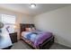 Cozy bedroom with a bed, natural light, and carpet flooring at 8905 W Jefferson St, Tolleson, AZ 85353