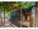 The wooden chicken coup is partially screened and has a wooden framed door at 8905 W Jefferson St, Tolleson, AZ 85353