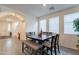 Dining room with large table, bench seating, and ample natural light from the windows at 8905 W Jefferson St, Tolleson, AZ 85353