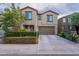 A traditional two-story home with neutral stucco exterior, a two-car garage, and neatly trimmed front bushes at 8905 W Jefferson St, Tolleson, AZ 85353