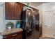 Modern kitchen with stainless steel refrigerator, dark wood cabinets, and granite countertops at 8905 W Jefferson St, Tolleson, AZ 85353