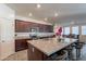 Kitchen featuring granite counters, stainless steel appliances, a large island, and stylish bar stools at 8905 W Jefferson St, Tolleson, AZ 85353
