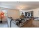 Spacious living room featuring a sectional couch, chandelier, and decorative entertainment center at 8905 W Jefferson St, Tolleson, AZ 85353