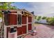 Outdoor shed offers storage in the backyard, surrounded by trees at 8905 W Jefferson St, Tolleson, AZ 85353