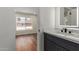 Stylish bathroom featuring a modern vanity, marble countertop and view to bedroom at 915 E Annette Dr, Phoenix, AZ 85022