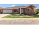 Charming home featuring a welcoming front yard, two-car garage, and decorative pillars at the entrance at 915 E Annette Dr, Phoenix, AZ 85022