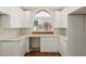 Bright kitchen features a modern sink, white cabinets, and large arched window overlooking the neighborhood at 915 E Annette Dr, Phoenix, AZ 85022