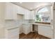 Updated kitchen with stylish white cabinetry, granite countertops, and contemporary backsplash at 915 E Annette Dr, Phoenix, AZ 85022
