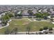 Expansive aerial view of a community park and the surrounding neighborhood featuring well-maintained landscaping and various community amenities at 12046 W Flores Dr, El Mirage, AZ 85335