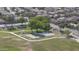 An aerial view of a community park with walking paths, recreational facilities, and lush green spaces surrounded by residences at 12046 W Flores Dr, El Mirage, AZ 85335