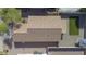 An aerial view of the home with tiled roof, pool, and backyard at 12046 W Flores Dr, El Mirage, AZ 85335