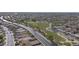Aerial view showcasing a well-planned community featuring homes, green spaces, and a parkway at 12046 W Flores Dr, El Mirage, AZ 85335