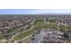 Community aerial view showcases homes near green space featuring a winding parkway, and desert landscaping at 12046 W Flores Dr, El Mirage, AZ 85335