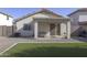Backyard featuring artificial turf, gravel, a covered patio, and block fencing for privacy at 12046 W Flores Dr, El Mirage, AZ 85335