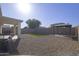 Spacious backyard showcasing gravel landscaping, artificial turf, and a gazebo with furniture at 12046 W Flores Dr, El Mirage, AZ 85335