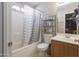 Bathroom featuring a shower-tub combo with updated fixtures and plenty of storage at 12046 W Flores Dr, El Mirage, AZ 85335