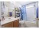 Bathroom featuring updated fixtures, vanity with plenty of storage, and a shower-tub combo at 12046 W Flores Dr, El Mirage, AZ 85335