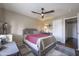 Comfortable bedroom featuring a ceiling fan, neutral paint, and cozy carpeted floor at 12046 W Flores Dr, El Mirage, AZ 85335