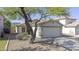 Charming single-story home with a well-maintained yard and attached two-car garage at 12046 W Flores Dr, El Mirage, AZ 85335