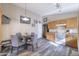 Eat-in kitchen featuring wood cabinets, modern appliances, and a cozy dining area at 12046 W Flores Dr, El Mirage, AZ 85335