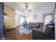 Open-concept living room with hardwood floors, vaulted ceiling, and lots of natural light at 12046 W Flores Dr, El Mirage, AZ 85335