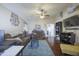 Cozy living room with hardwood floors, a ceiling fan, and neutral wall colors at 12046 W Flores Dr, El Mirage, AZ 85335