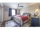 Main bedroom featuring carpeted floors, a ceiling fan, and a large window for natural light at 12046 W Flores Dr, El Mirage, AZ 85335