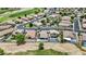 A view of a neighborhood with several homes, pools, and lush golf course views at 12214 W Madison St, Avondale, AZ 85323