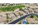 An aerial shot showing a golf course view and several homes with mature landscaping at 12214 W Madison St, Avondale, AZ 85323