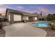 Inviting backyard featuring a pool, patio, and lush landscaping perfect for outdoor relaxation and entertaining at 12214 W Madison St, Avondale, AZ 85323