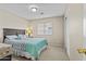 Comfortable bedroom with a queen bed, closet, and soft natural light shining through the window at 12214 W Madison St, Avondale, AZ 85323