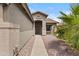 Charming home entrance with landscaped walkway, arched doorway, and inviting front porch at 12214 W Madison St, Avondale, AZ 85323