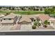 Well-maintained front yard of a home featuring mature landscaping, and a spacious three-car garage at 12214 W Madison St, Avondale, AZ 85323