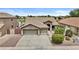 Well-manicured front yard with mature landscaping of a beautiful home at 12214 W Madison St, Avondale, AZ 85323