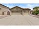 Spacious three-car garage with ample parking and curb appeal enhancing the home's facade at 12214 W Madison St, Avondale, AZ 85323