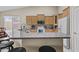 Stylish kitchen featuring granite countertops, modern appliances, and a convenient breakfast bar at 12214 W Madison St, Avondale, AZ 85323