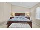 Inviting main bedroom featuring a king bed, two nightstands, and decorative lamps at 12214 W Madison St, Avondale, AZ 85323