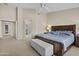 Large main bedroom with a king bed, seating, ceiling fan, and en-suite bathroom access at 12214 W Madison St, Avondale, AZ 85323
