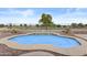 Inviting kidney-shaped pool features decorative accents, surrounded by low-maintenance landscaping at 12214 W Madison St, Avondale, AZ 85323