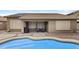 Backyard features a pool and covered patio with seating, perfect for outdoor relaxation at 12214 W Madison St, Avondale, AZ 85323